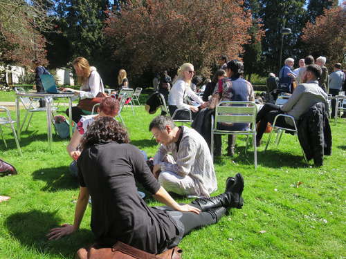Conversation continues on sunny lawn of Stamford Court, University of Leicester